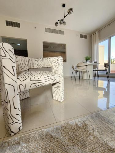 a living room with a couch and a table at Live and experience Al Marjan Island 1BR in Ras al Khaimah