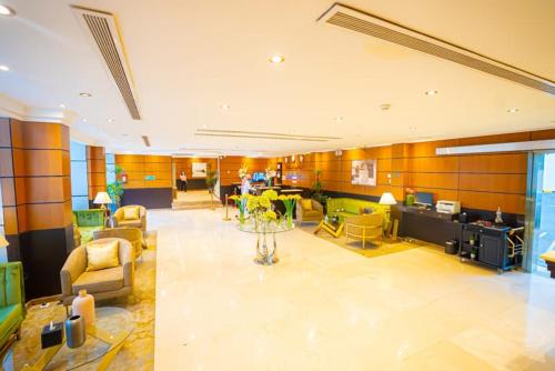 a large lobby with chairs and tables in a building at Al Muhaidb Palastine - Jeddah in Jeddah