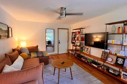 a living room with a couch and a table at The Mod Cabin in Bearsville