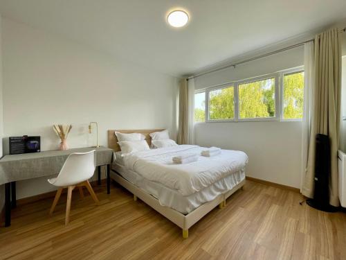 a bedroom with a bed and a desk and a window at KoalaWakeup in Vitry-sur-Seine