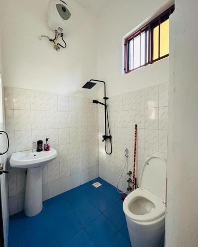 a bathroom with a toilet and a sink at paje zanzibar apartment in Paje