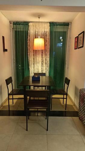 a dining room with a table and chairs and a window at 2BHK in Siolim, North Goa Cozy Monsoon Retreat in Siolim