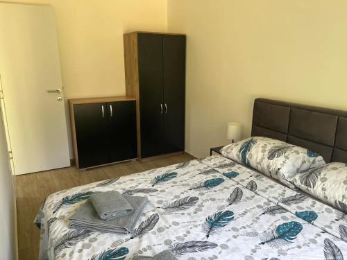 a bedroom with a bed and a black cabinet at HARIZMA LUX Banja Vrujci in Popadić