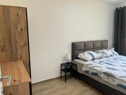 a bedroom with a bed and a table with a lamp at HARIZMA LUX Banja Vrujci in Popadić
