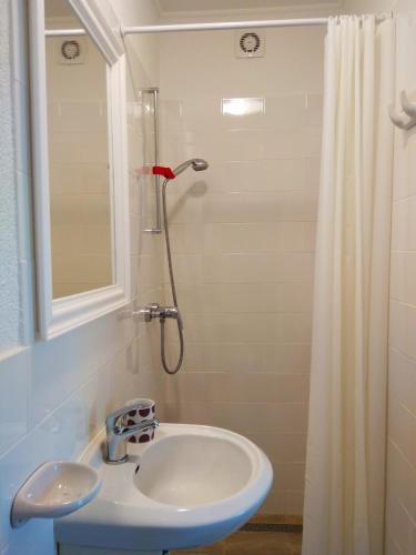 a bathroom with a sink and a shower at апартаменты Sоlо in Hévíz