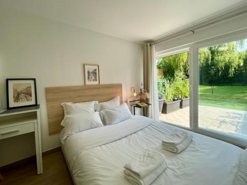 a bedroom with a large white bed with towels on it at KoalaWakeup in Vitry-sur-Seine