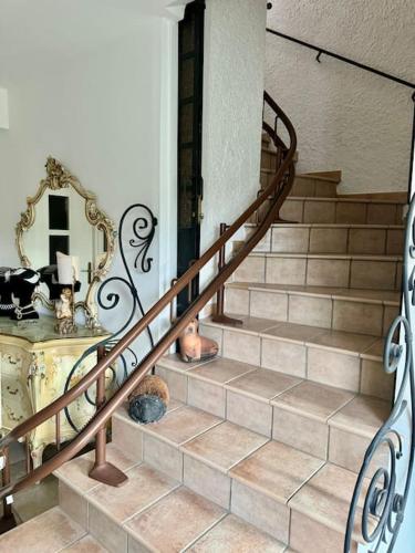 a spiral staircase in a home with a mirror at La Casa Della Principessa con terrazza mozzafiato in Barbarano Romano
