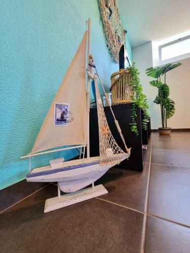 a wooden sailboat on display in a room at O Cantinho do Zé in Funchal