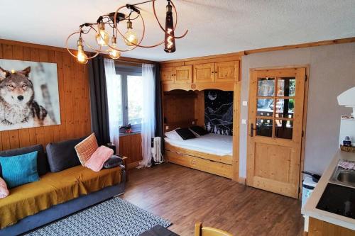 a living room with a couch and a bedroom at Appartement vue Montblanc 5mn piste2 in Les Trabets