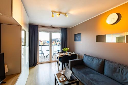 a living room with a couch and a table at Apartamenty City Tower od WroclawApartament-pl in Wrocław