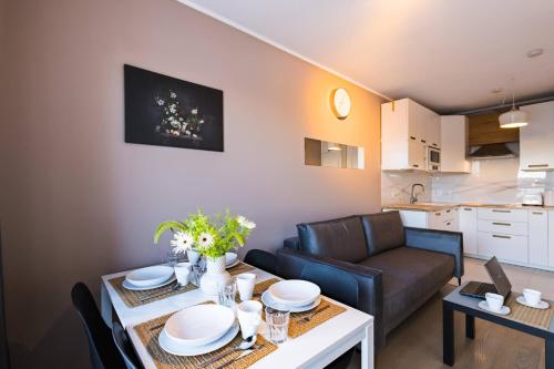 a living room with a couch and a table at Apartamenty City Tower od WroclawApartament-pl in Wrocław