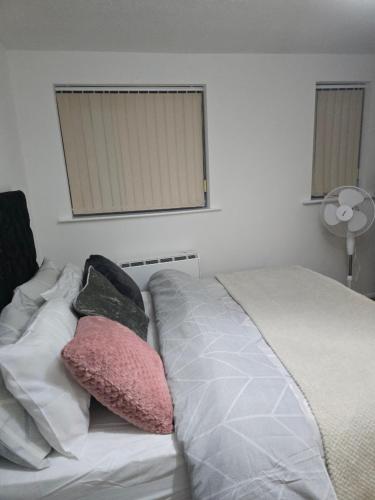 a bed with two pillows on it in a bedroom at Emerald Apartments A star Proximity in London