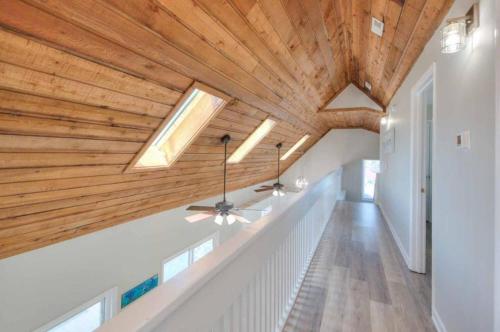 a hallway with a wooden ceiling with skylights at Dune Alright in Oak Island