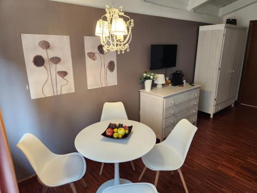 a dining room with a white table and chairs at Gaia Suites - A due passi dal centro - Parcheggio privato in Turin