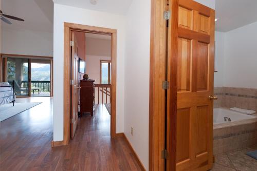 ein Badezimmer mit einer Holztür und einer Badewanne in der Unterkunft 210 Sheol Street in Durango Mountain Resort