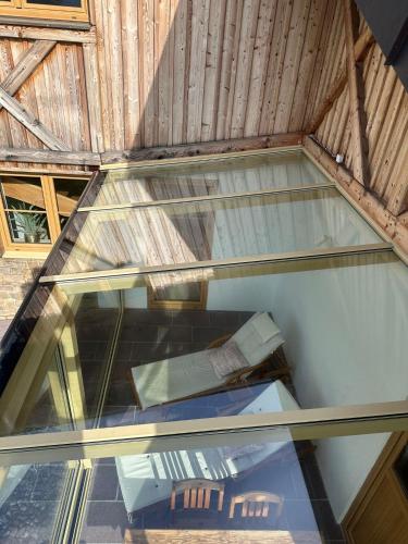 a glass ceiling with a table and a chair at Ferienhaus an der Drau in Sankt Oswald