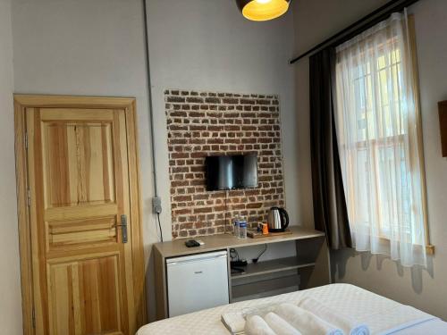 Un dormitorio con una cama y una pared de ladrillo. en HanFlats, en Estambul