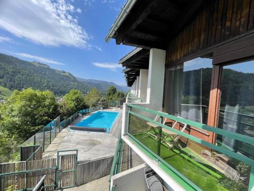 - un balcon d'une maison avec une piscine dans l'établissement Aravis 1500-11 - 2 pieces et coin nuit, à La Clusaz
