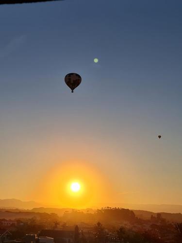 a kite flying in the sky at sunset at Hotel Ficare Torres in Torres
