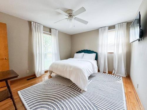 a bedroom with a bed with a ceiling fan and a rug at Sumner Ave in Gallatin