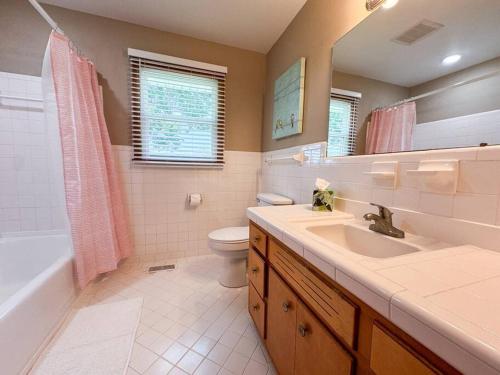 a bathroom with a sink and a tub and a toilet at Sumner Ave in Gallatin