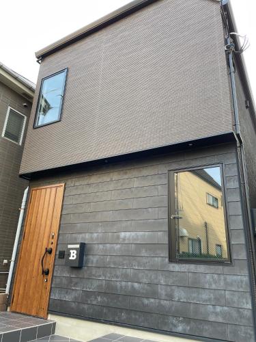 a building with a large door and a window at COTO Premium Shibuya B in Tokyo