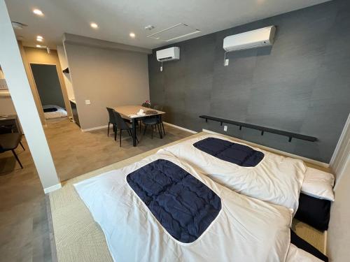 a bedroom with a large bed and a table at COTO Premium Shibuya B in Tokyo