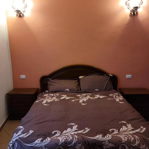 a bedroom with a bed with two night stands and two lights at La Vecchia Riseria 1 in Novara