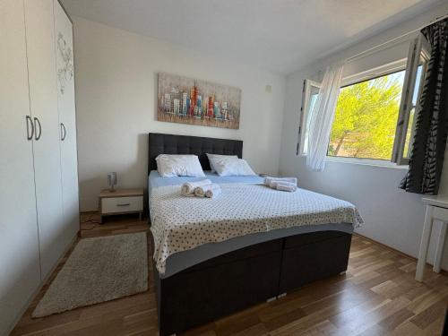 a bedroom with a bed with two teddy bears on it at Apartments Rotim, Mljet, Sutmiholjska in Babino Polje