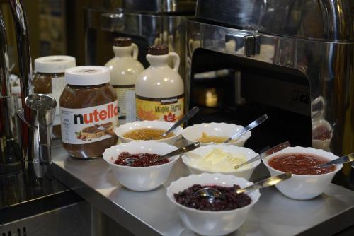 a counter with bowls of food in a kitchen at Best Western Hotel Akersberga in Åkersberga