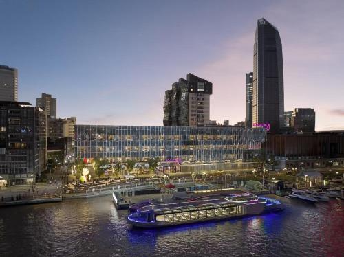 two boats are docked in a river in a city at Moxy Ningbo Old Bund in Ningbo