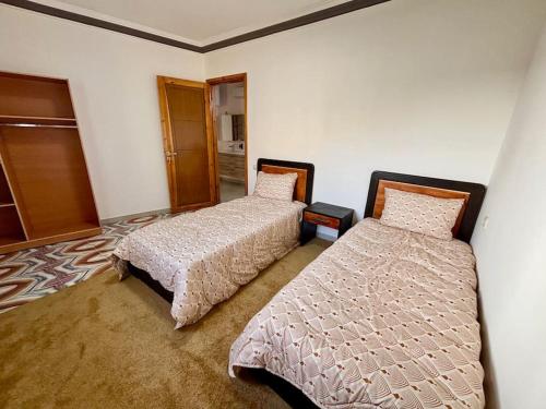 a bedroom with two beds in a room at Cabane Ouirgane in Aït Zat