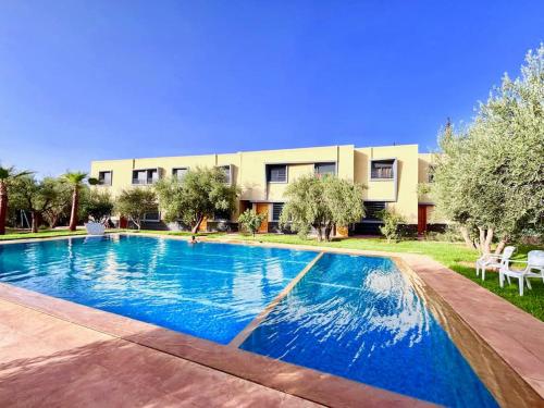 a large swimming pool in front of a building at Cabane Ouirgane in Aït Zat