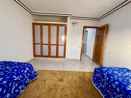 a room with two beds and a door in it at Cabane Ouirgane in Aït Zat