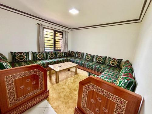 a living room with a couch and a table at Cabane Ouirgane in Aït Zat