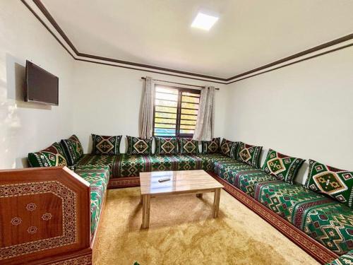 a living room with a couch and a table at Cabane Ouirgane in Aït Zat