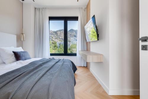 a bedroom with a bed and a window at NEW Luxury villa I infinity pool in Starigrad-Paklenica