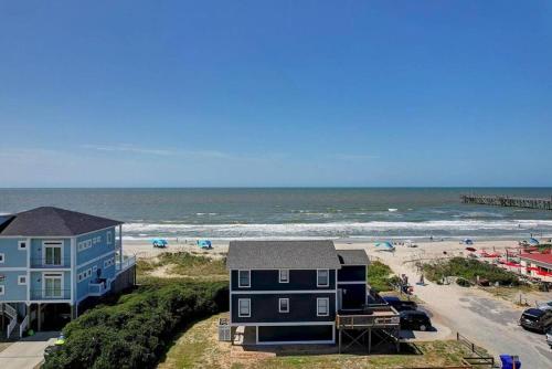 a view of a beach with houses and the ocean at Dune Alright in Oak Island