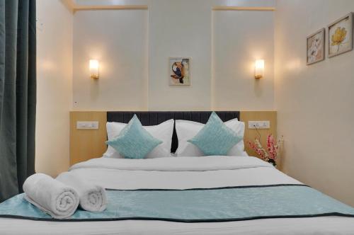 a bedroom with a large bed with towels on it at Urban Hometel in Pune