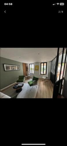 Elle comprend un grand salon doté d'un mobilier vert et de fenêtres. dans l'établissement Villa magnifique vue mer, à Marseille