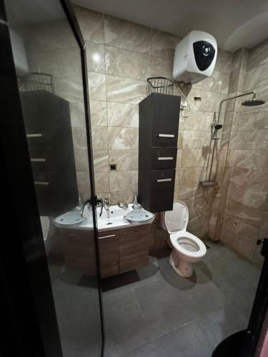 a bathroom with a toilet and a sink and a shower at Teranga sn in Dakar