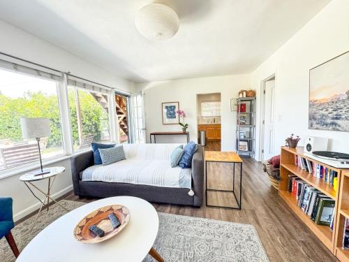 a living room with a couch and a table at Serene and beautiful hillside retreat in Glendale
