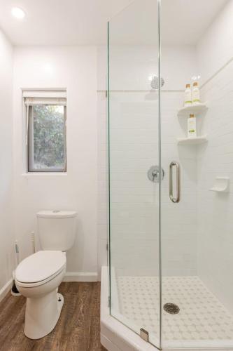 a bathroom with a toilet and a glass shower at Serene and beautiful hillside retreat in Glendale