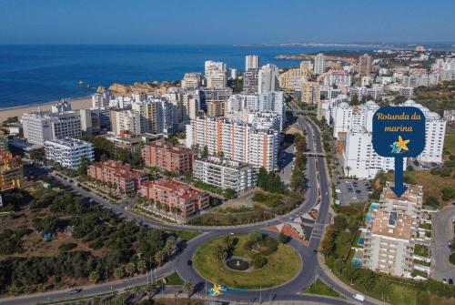 an aerial view of a city with a highway at Rotunda da Marina in Portimão