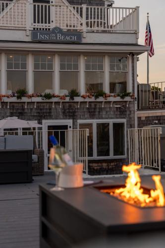a fire pit in front of a hotel with a building at Inn on the Beach in Harwich Port