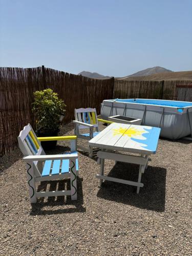 two chairs and a table and two tables and a boat at Casa-Molino in Tuineje