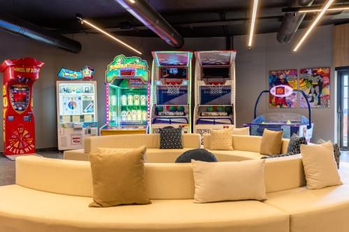 a room with several arcade games and couches at Elios Hill in Hersonissos