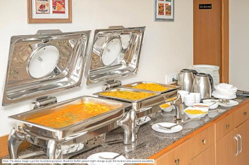 a kitchen with two trays of food on a counter at Glitz Hotels The Pacific - Nr Solitaire Corporate Park in Mumbai