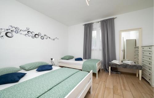 a bedroom with two beds and a mirror at Gorgeous Home In Labin in Labin