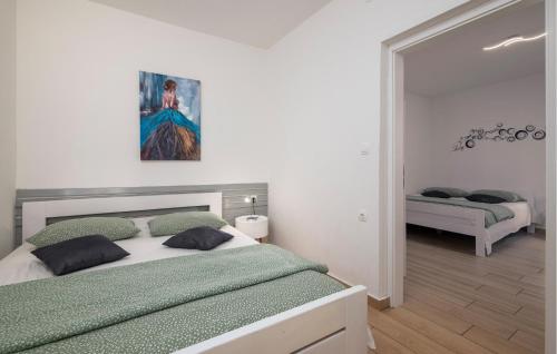 a bedroom with a bed and a painting on the wall at Gorgeous Home In Labin in Labin